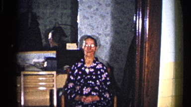 1960: old women sitting in her beautiful house waiting for her son to return