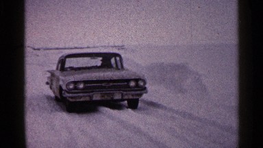 1960: man getting out of late model chevrolet car that is parked