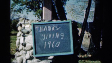 1960: placard stating 'thanksgiving 1960' ,and family dressed up. SIOUX FALLS