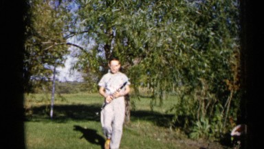 1960: the view of the low angle view the park walk the boy take a some things