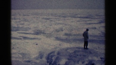 1961: a lone figure stands on a barren ice sheet. DULUTH MINNESOTA