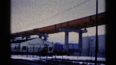 1961: a huge bridge like structure in an area with buildings and constructions