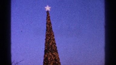 1964: tall narrow christmas tree topped with a star and festooned