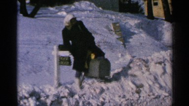 1965: lady plays with snowfall MINNESOTA