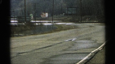 1965: high way road with wire in platform and car is trespassing in road