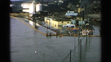 1965: flood waters cover a built-up, industrial area and train tracks
