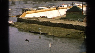 1965: water that looks like a dam two boat house are located at the center