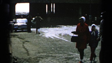 1965: family walking home, from a nice day at the lake when it starts to rain.