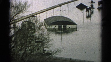 1965: flood waters reach high up on farm buildings in a valley MINNESOTA