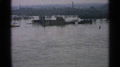 1965: a river with surrounding a small nature background trees and plants