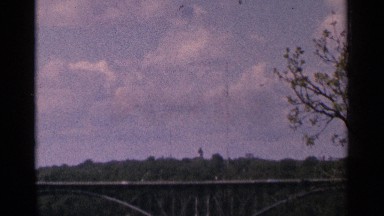 1964: view of cars on a bridge over the river MINNESOTA