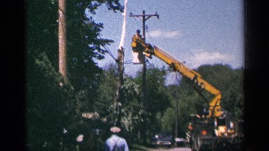1964: a large piece of construction equipment working outside near vegetation