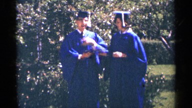 1964: two graduate students stand and talking each other about the study