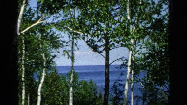 1964: zooming into a boat off in the distance, vintage clip