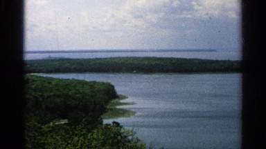 1964: water and some trees near to the water and no one is not at the place