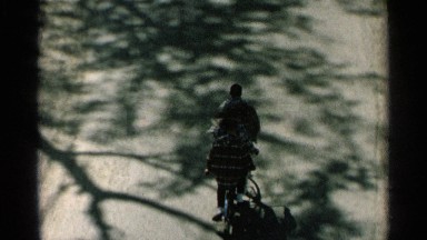 1964: three people riding a tandem bicycle down a road. WASHINGTON ISLAND