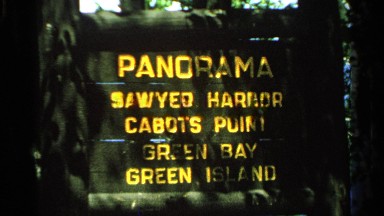 1964: gold letters on wood sign lists four places of interest from one view