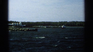 1964: there are some buildings are shown and the man traveled on the boat