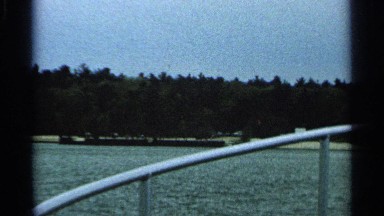 1964: view of a wooded shoreline from a ship on the water WASHINGTON ISLAND
