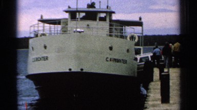 1964: the video shows the boat is parked in port and many people