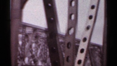 1965: footage of a bridge and water taken from a car window. ARKANSAS
