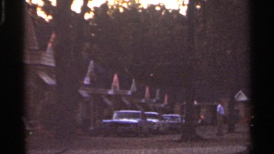 1965: cars and trucks are parked at motel lot with individual gabled roofing