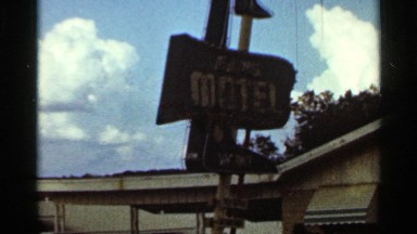 1965: the name board write a letter yellow color and wood next to the house