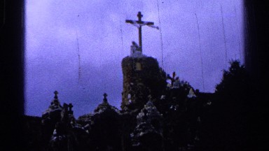 1965: church like building model captured at evening time with cross symbol