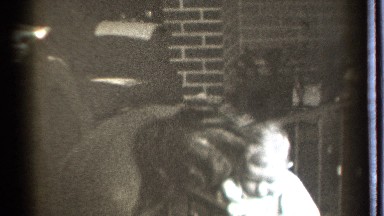 1939: A Woman Helping Her Chubby Baby Stand and Walk in Danielson, Connecticut