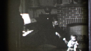 1939: a happy family gathers around a fireplace to socialize. DANIELSON