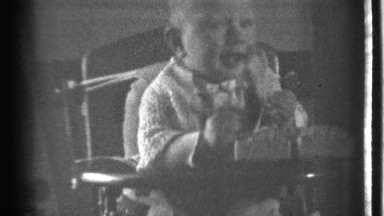 1939: the small children play in the rolling chair in the house collect the