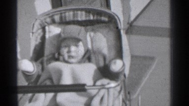 1939: baby dressed really warm sitting in a stroller. DANIELSON CONNECTICUT