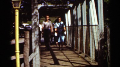 1966: happy couple walking on the bridge in a sunny day SAINT LOUIS MISSOURI