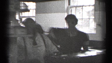 1944: steam rises from pots in an industrial kitchen as people cook