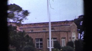 1944: red and brown bricked school with similar windows leading to the entrance