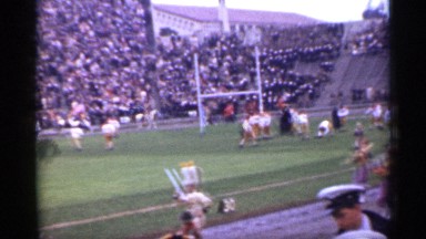 1944: vintage video: crowd gathers in stadium to watch marching band at football