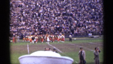 1944: stadium spectators watch marching band cross width of football field