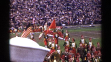 1944: parade in an football ground people were walking in orange uniform