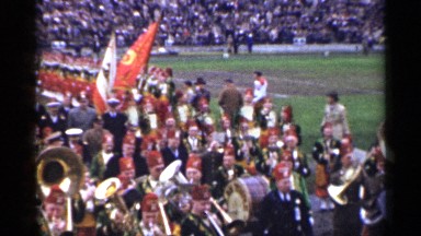 1944: parade is happening side to the ground where a game is playing