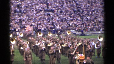 1944: military marching band finishing performance in a football stadium