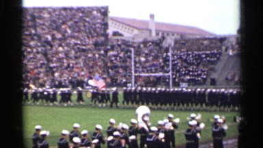 1944: a very large band is walking in a curved line while playing the drums