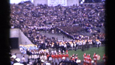 1944: marching band entering a football field during sporting event