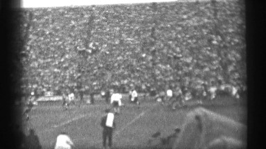 1944: football game on the field viewed by a large stadium of crowds