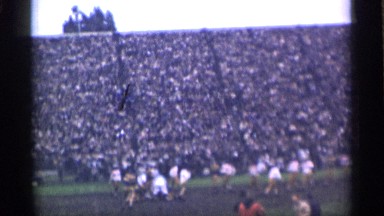1944: the football game organized in a ground front of many people and fans.