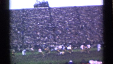 1944: a rugby match is played by players in ground many people