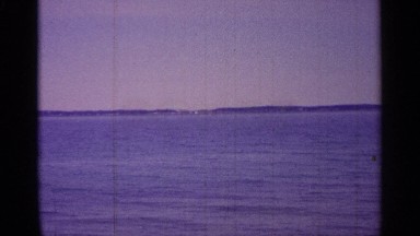 1960: traveling boat's oceanside view of the destination afar. MICHIGAN
