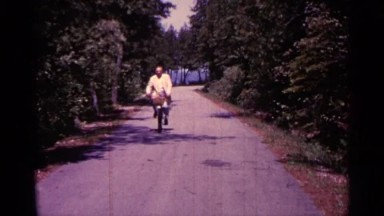 1960: man on bicycle makes face MICHIGAN
