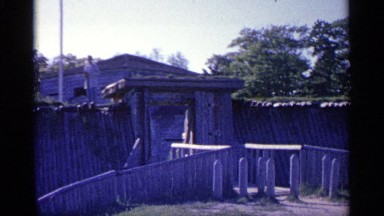 1960: man standing on top of a log fence. MICHIGAN
