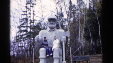1960: two man site the statue near to the heavy tree green leaf MICHIGAN
