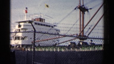 1960: a large white and black ship is docked in the water at a port MICHIGAN